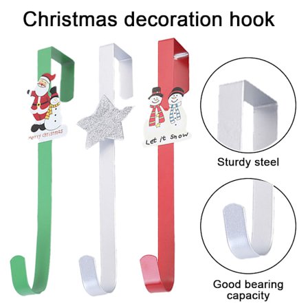 Metallinen seppelekoukku jouluseppeleelle oven päällä