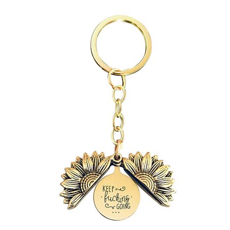 Kultainen auringonkukan avaimenperä kaiverretulla riipuksella