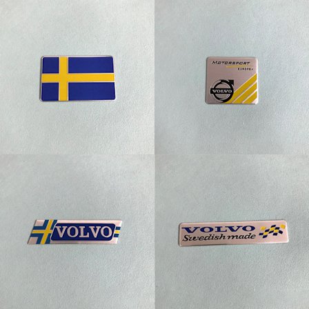(Neliönmuotoinen Ruotsin lippu + neliönmuotoinen Volvo-logo + VOLVO suunnikas +-FA-