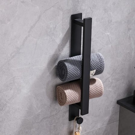 En vanlig svart handdukshängare som inte behöver borras, med en