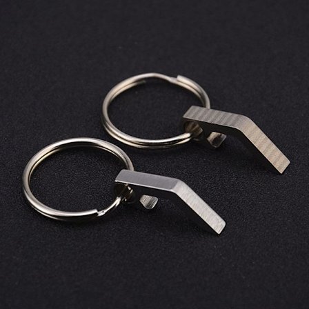 Nyckelring i titan med kapsylöppnare i rostfritt stål