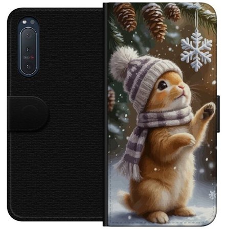 Kompatibelt Plånboksfodral till Sony Sony Xperia 5 II Vinterkanna med mössa och halsduk beundrar en snöflinga, ett varmt och charmigt vintermotiv f