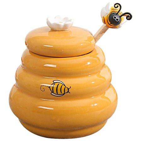 Keraaminen mehiläispesän hunajapurkki ja puinen kauha hunajapurkki kannella hunajasekoitustikku hunajapurkkitarvikkeille keittiötarvikkeet
