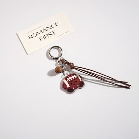 Tegneserie Q-versjon nøkkelringer, sportsutstyr nøkkelringer, brun