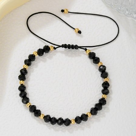 Armbånd, prydet med guldperler og facetslebne sorte onyx halvædelsten, justerbart.