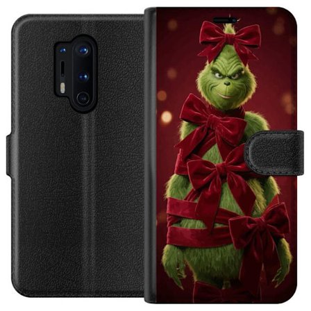 Yhteensopiva Lompakkokotelo OnePlus OnePlus 8 Pro Grinchi-hahmo koristeltu punaisilla samettinauhoilla juhlavassa studiossa, leikkisällä ja humorist