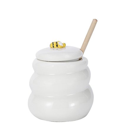 Keraaminen mehiläispesän hunajapurkki ja puinen kauha hunajapurkki kannella hunajasekoitustanko hunajapurkille