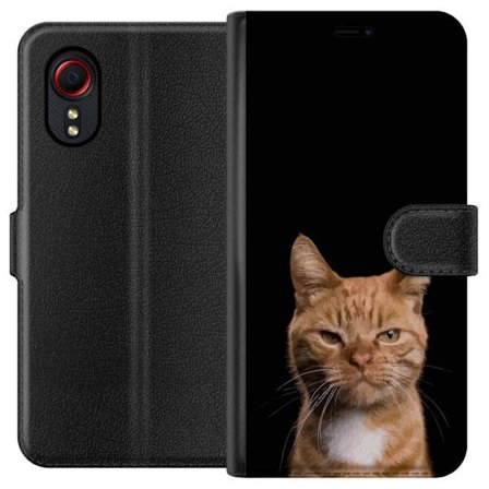 Kompatibelt Plånboksfodral till Samsung Samsung Galaxy Xcover 5 Närbild av orange katt mot svart bakgrund, uttrycksfull blick och hög kontrast som