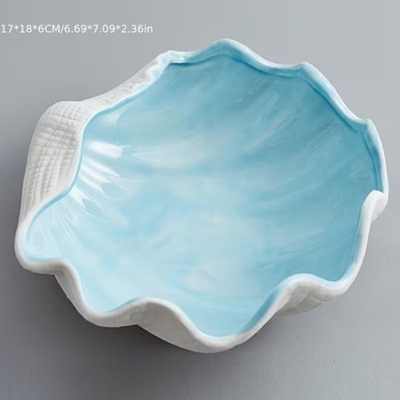 En ocean-tema smykkeopbevaringsbakke i keramik, i en simuleret muslingeskalsfarve.