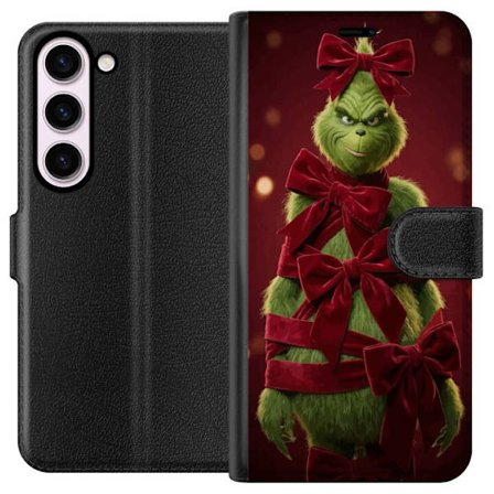 Kompatibelt Lommeboketui til Samsung Galaxy S23 Grinchen figur dekorert med røde fløyelsbånd i en festlig studioinnstilling med leken og humoristisk f