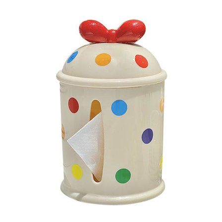 Rund hvit keramisk tørkepapirholder med fargerikt polkadotmønster og rød sløyfedekorasjon på lokket for bruk i hjem, bad eller kontor