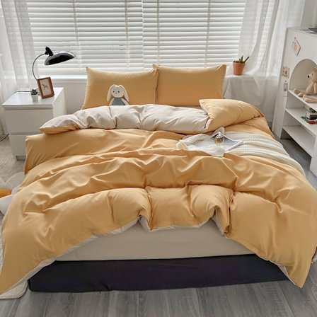 Keltainen neljän osan vuodevaatesetti, jossa on vuodehame, peitto ja tyynyliinat